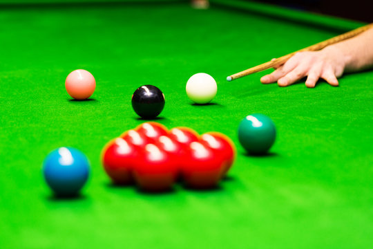 snooker - hand aiming the cue ball