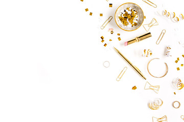 Beauty blog background. Gold style feminine accessories. Golden tinsel, scissors, pen, rings, necklace, bracelet on white background. Flat lay, top view.