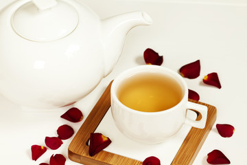Hot tea in white cup and teapot