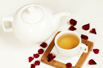 Hot tea in white cup and teapot