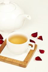 Hot tea in white cup and teapot