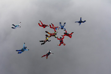 Naklejka na ściany i meble The group of skydivers is in the sky.