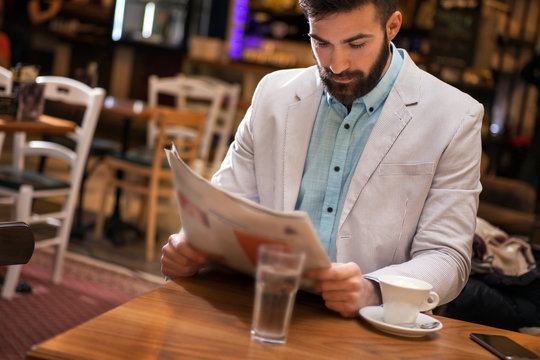modern businessman reading newspaper