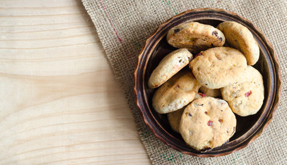 Healthy homemade cookies in a wooden bowl on a jute pad - top view