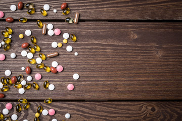 Colorful pills on wooden background