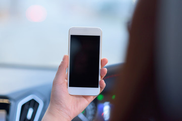 People using smart phone in car.