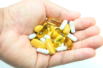 Vitamin and pill on hand