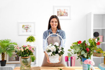 Pretty young florist at workplace