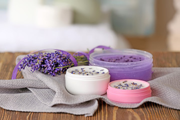 Obraz na płótnie Canvas Set of body care cosmetics with lavender on wooden table