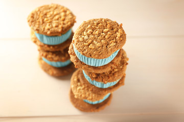 Tasty kiwi ice cream cookie sandwiches on wooden table