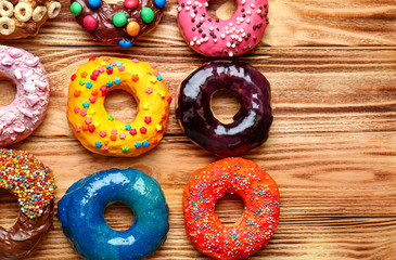 Glazed donuts on wooden background