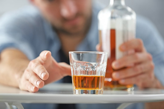 Male hand with glass of whisky, closeup