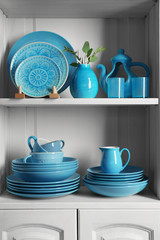 Wooden shelves with blue rustic dinnerware