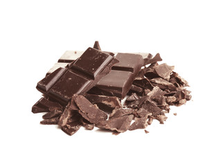 Broken dark chocolate pieces with morsels on white background