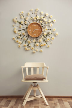 Clock decorated with flowers on wall