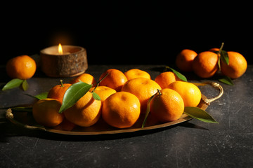 Vintage tray with tangerines on dark background