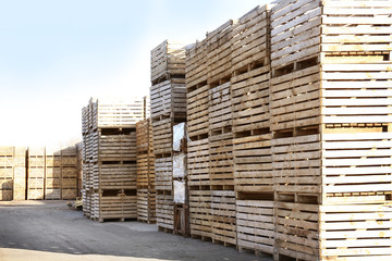 Wooden boxes in open-air warehouse on sunny day