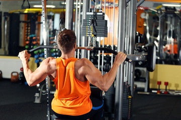 Young man training in modern gym