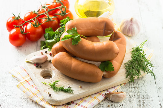 Uncooked sausages with vegetables