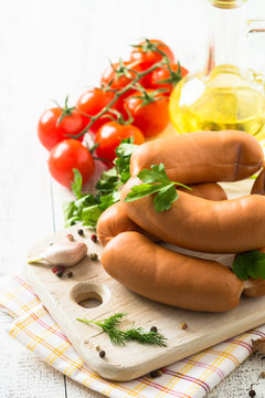 Uncooked sausages with vegetables