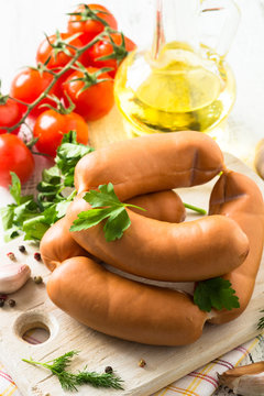 Uncooked sausages with vegetables