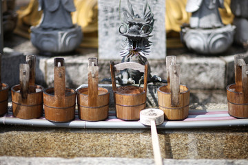 Obraz na płótnie Canvas Ritual vessels and wooden bucket for washing hands in a Shinto temple