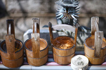 Ritual vessels and wooden bucket for washing hands in a Shinto temple