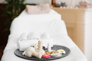 Fototapeta na wymiar Set of natural treatments on bed in spa salon