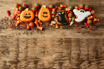 Halloween cookies and jelly sweets on wooden background