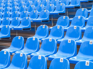 Naklejka premium Blue plastic chairs on a tribun, Portugal, Madeira, Funchal