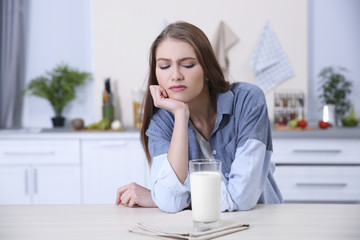 Young woman refusing to drink milk