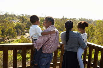 Grandparents And Grandchildren Standing On Observation Deck