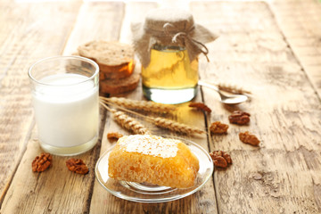 Composition with milk, honey and bread on wooden background