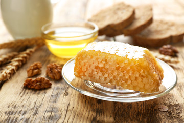 Plate with honeycomb on wooden table