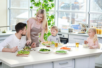 Happy family having breakfast at home