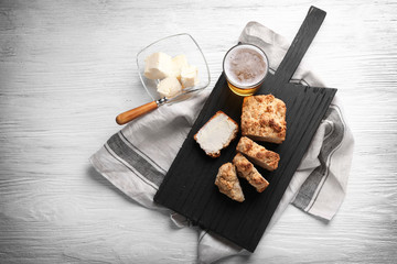 Wooden cutting board with sliced loaf of beer bread and butter