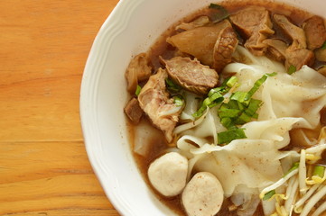 large rice noodle with braised pork and ball in brown soup