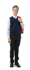 Teenage boy in school uniform with backpack on white background