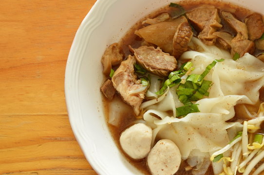 large rice noodle with braised pork and ball in brown soup