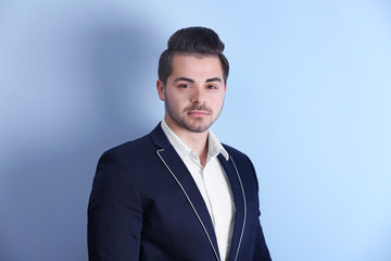 Handsome young man on color background
