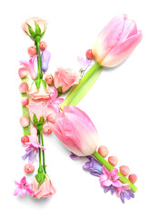 Letter K made of flowers on white background