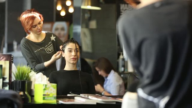 Woman Getting Hair Styled In Salon