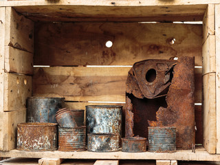 Rusted Aluminum Cans inside Wooden Container