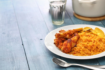 jollof rice with chicken and fried plantain, west african cuisine © uckyo