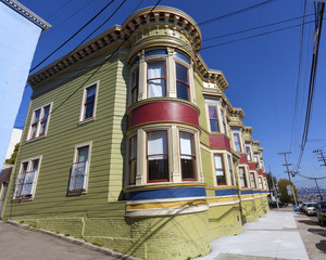 Vintage San Francisco Victorian style apartment building with traditional bay windows.