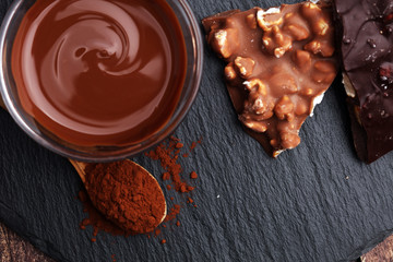 Melting chocolate and diffrent bars - stack and chips with chocolate swirl/ powder and cocoa pod with melted chocolate