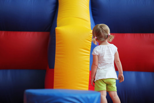 Little Girl looking at MoonBounce