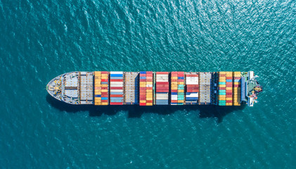 container ship in import export and business logistic.By crane ,Trade Port , Shipping.cargo to...