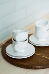 White tea set on a tray, kitchen table