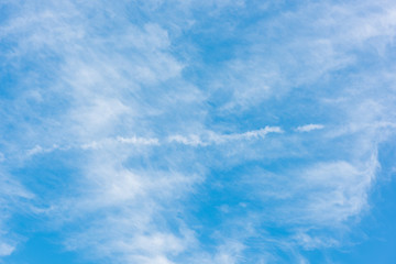 Fototapeta premium Contrails against the blue sky, Pattern of clouds in the blue sky, blue sky with cloud.